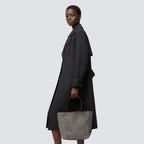 Black and brown chevron knit tote bag carried by hand with an everyday outfit