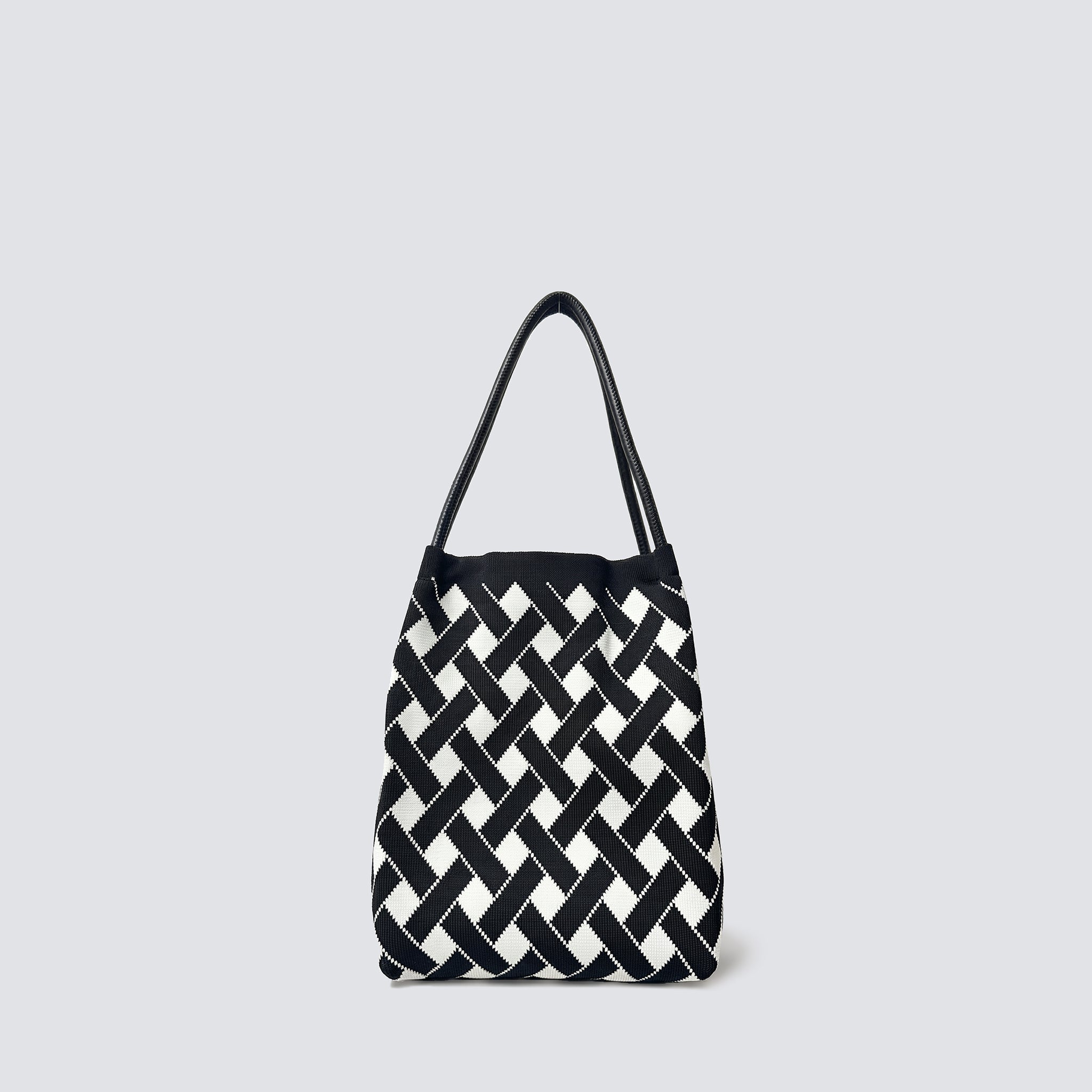 Black and white checkerboard knit tote bag on a simple product background