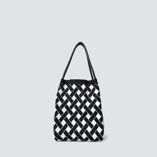 Black and white checkerboard knit tote bag on a simple product background