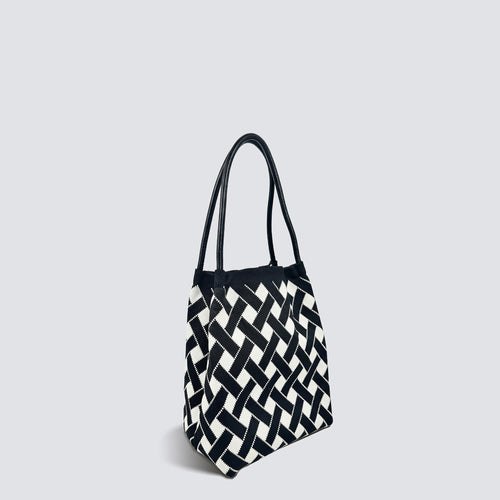 Black and white checkerboard knit tote bag shown with slender handles