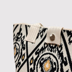 Close-up of the black and white patterned knit texture on a tote bag
