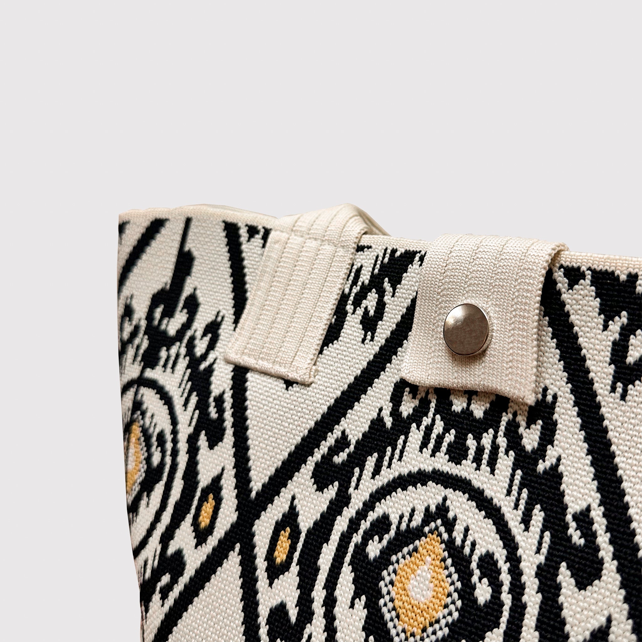Close-up of the black and white patterned knit texture on a tote bag