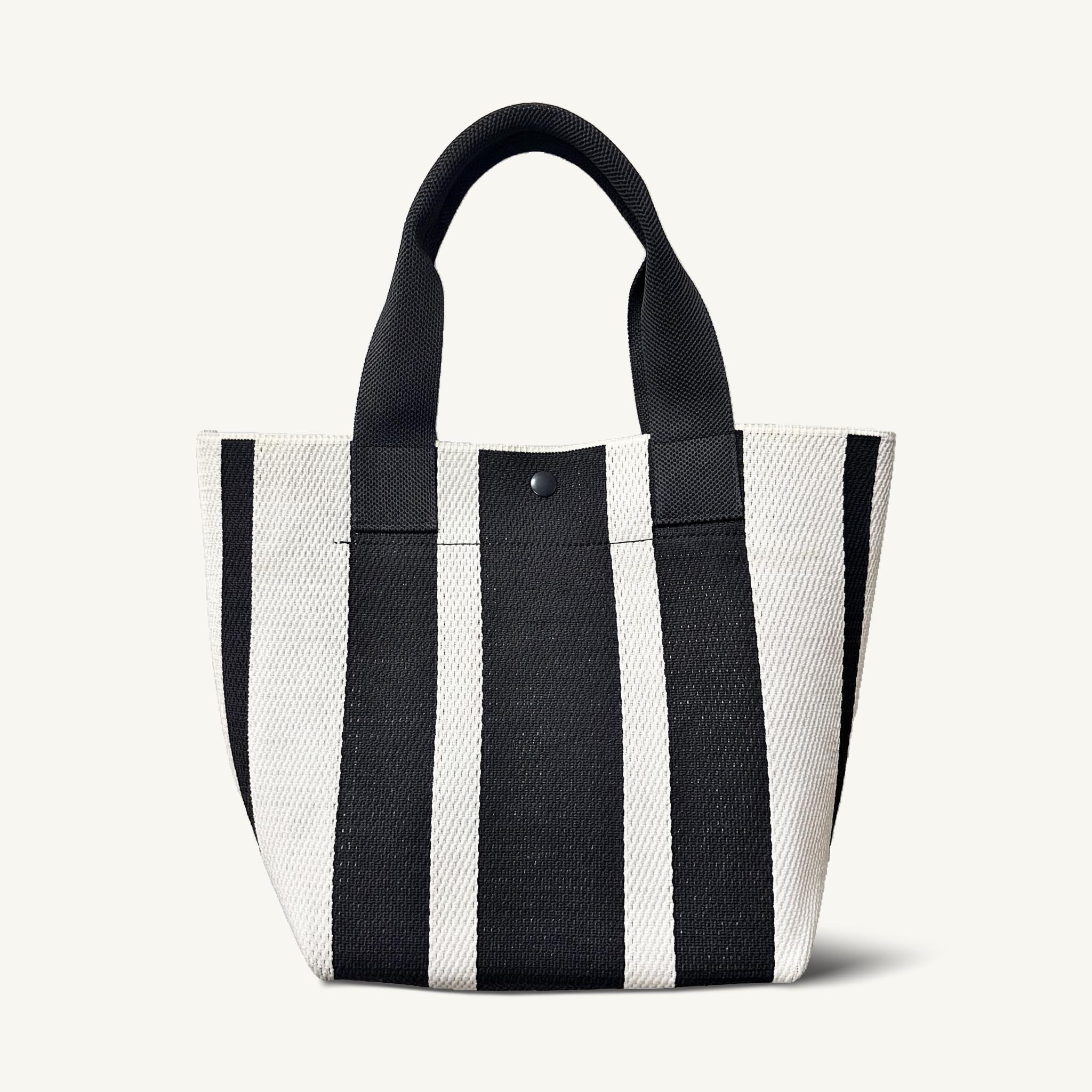 Black and white striped knit tote bag with short handles, front view
