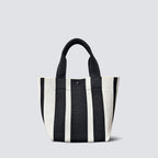 Black and white striped knit tote bag with short handles on a simple product background