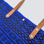 Close-up of the blue bohemian knit pattern and brown handles on a tote bag