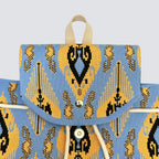Front detail of a blue and gold bohemian knit backpack with drawstring closure