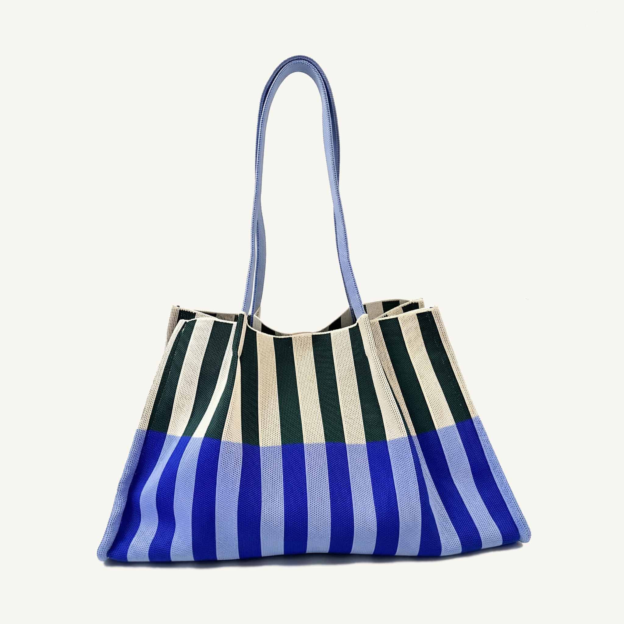 Oversized blue and green striped knit tote bag with blue shoulder straps, front view