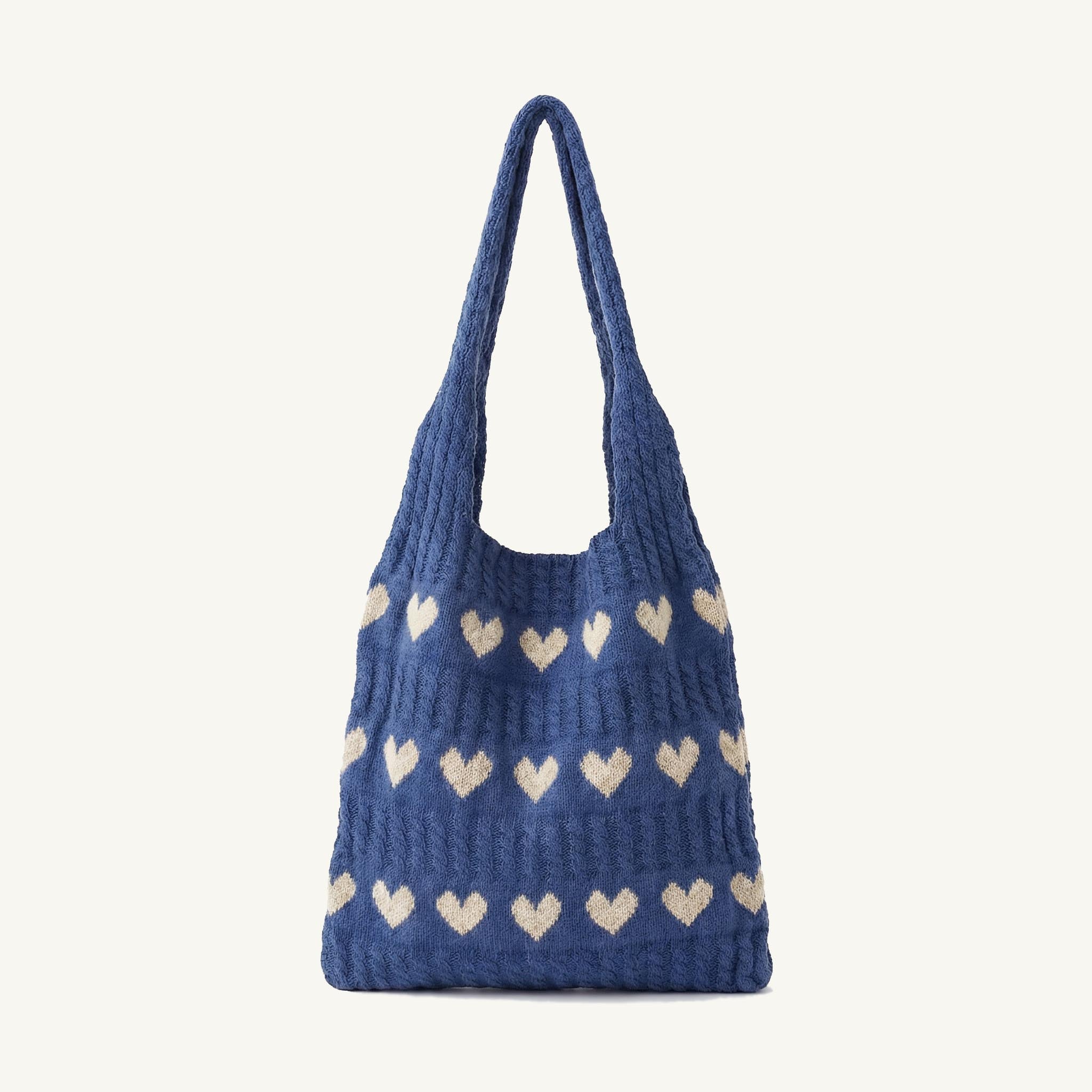 Blue heart-patterned knit hobo bag, front view