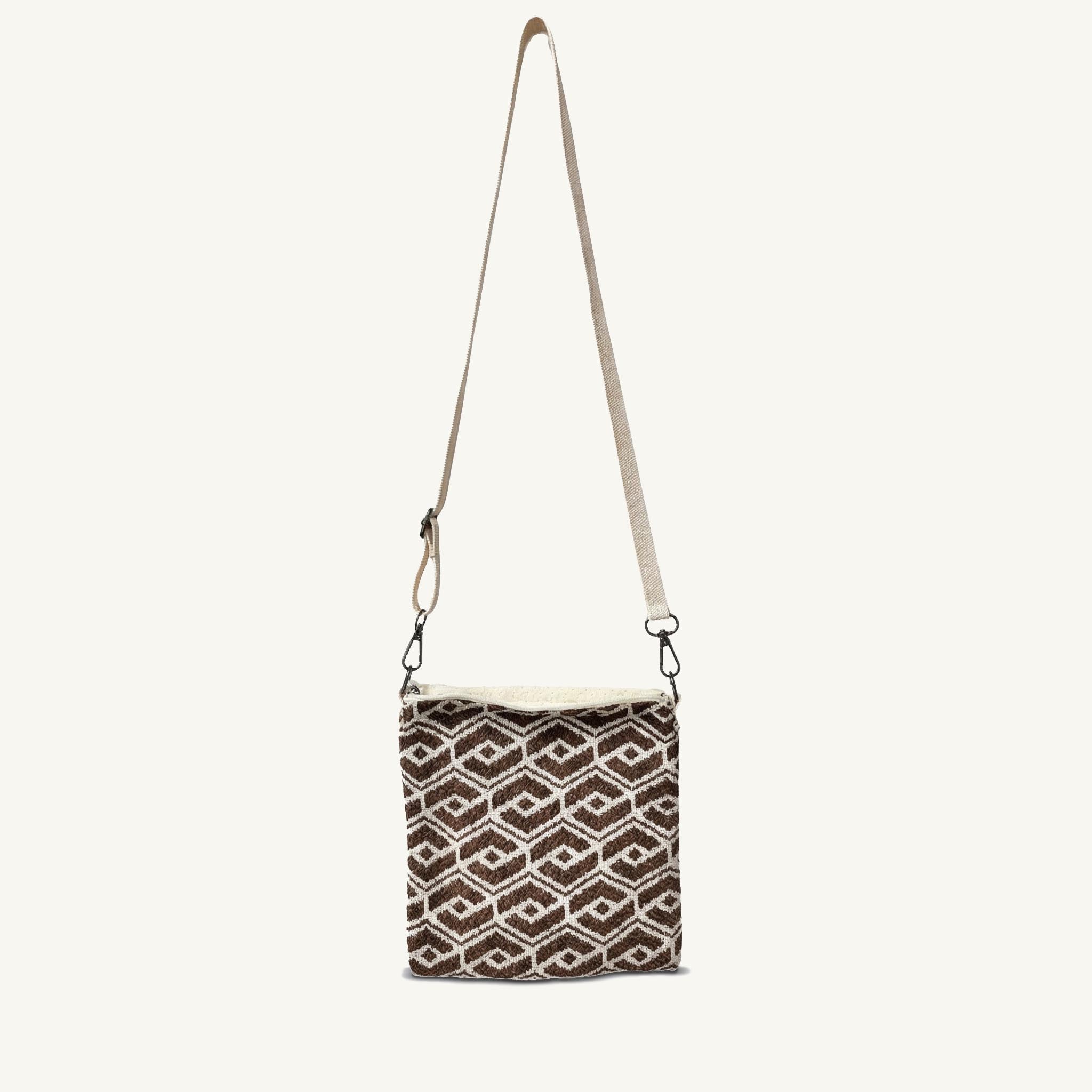 Brown geometric patterned knit crossbody bag with adjustable strap, front view