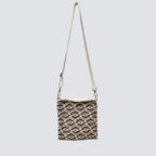 Brown patterned knit crossbody bag with an adjustable strap on a simple product background