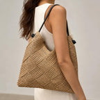 Woman carrying The Capri woven straw tote bag over the shoulder