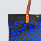 Close-up of the dark blue and black patterned knit texture on a tote bag