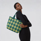 Woman carrying a green argyle knit tote bag with an everyday outfit