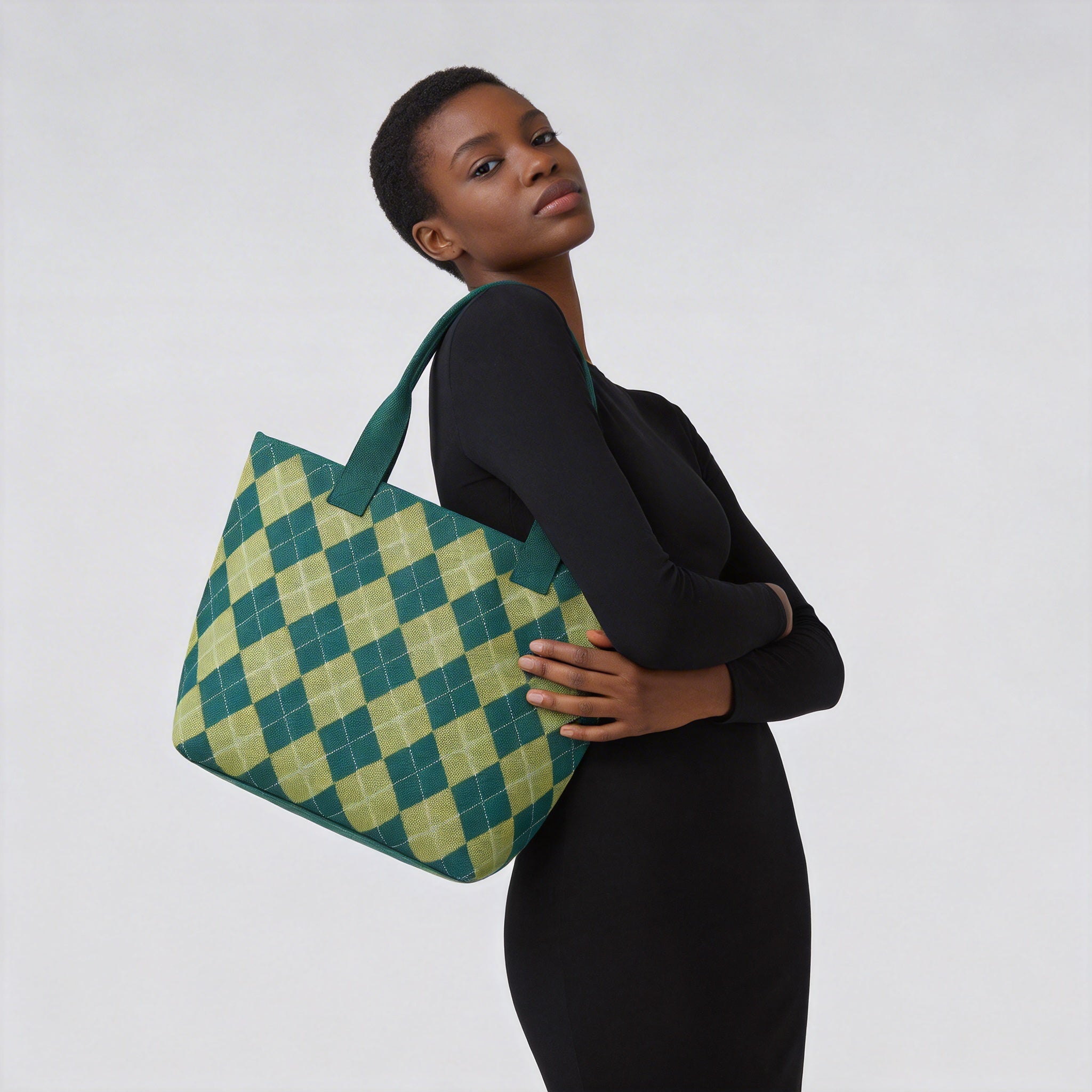 Woman carrying a green argyle knit tote bag with an everyday outfit