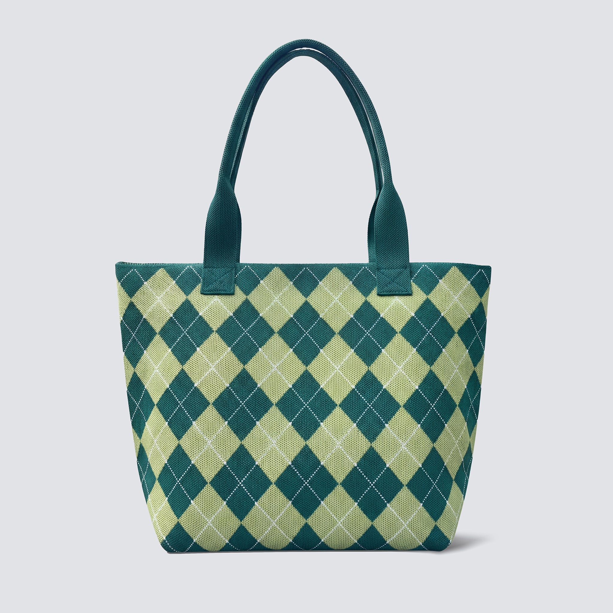 Green argyle knit tote bag with matching handles on a simple product background