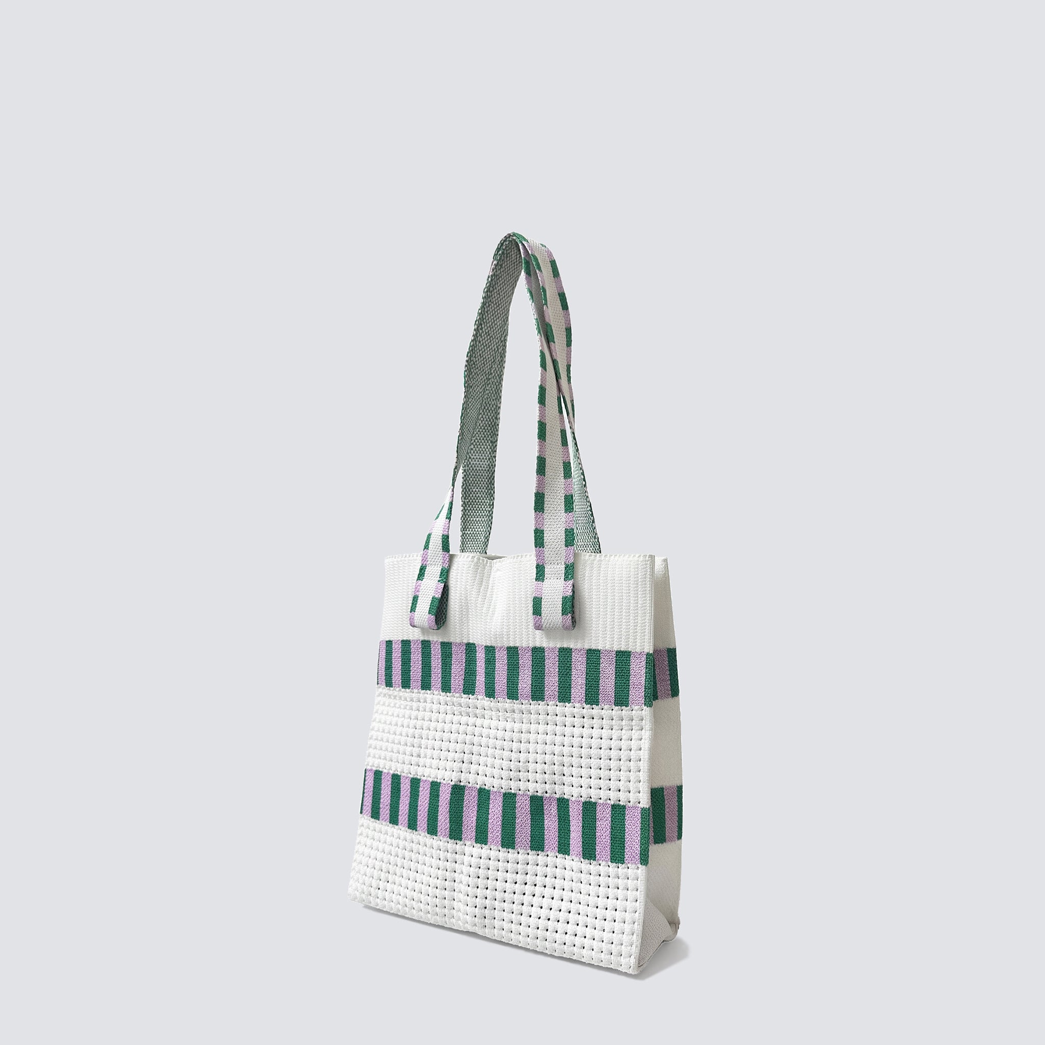 Side view of a green and white grid knit mini tote bag with double handles