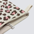 Close-up of the leopard print knit texture and zipper on a mini pouch makeup bag