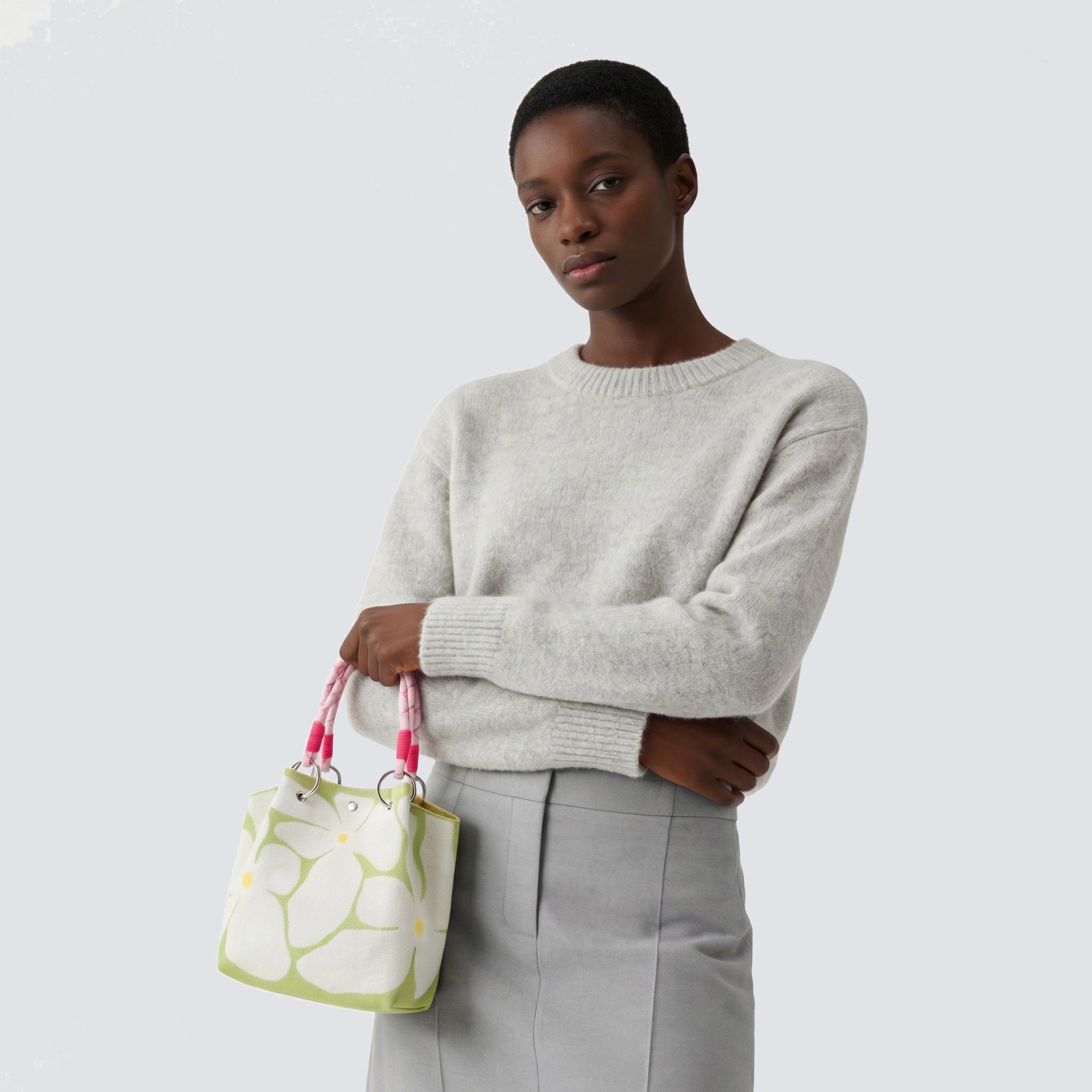 Light green patterned knit mini tote bag styled with a relaxed everyday look