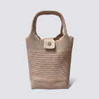 Natural woven mini beach tote bag with top handles on a simple product background