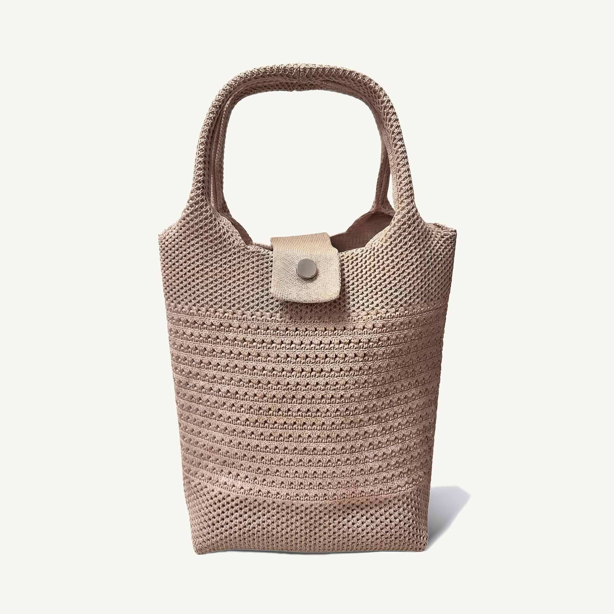 Natural woven mini beach tote bag with button closure, front view