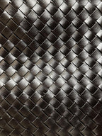 Close-up of the wide woven vegan leather texture on The Onyx black shoulder bag