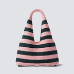 Pink and navy blue striped knit beach bag on a simple product background