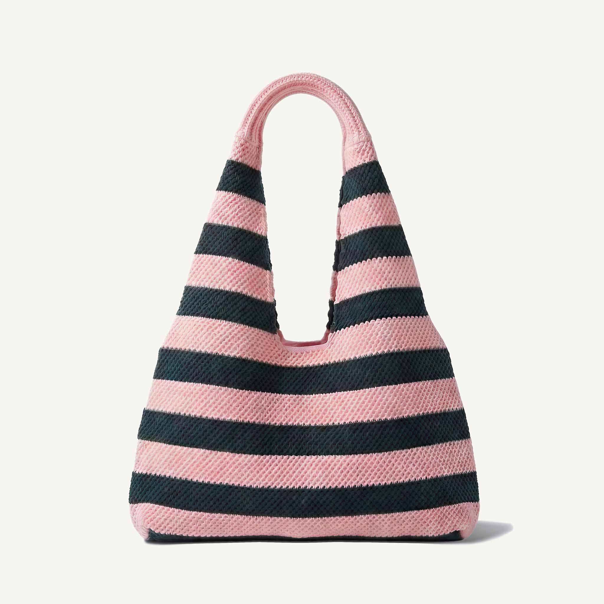 Pink and navy blue striped knit beach bag with wide shoulder straps, front view
