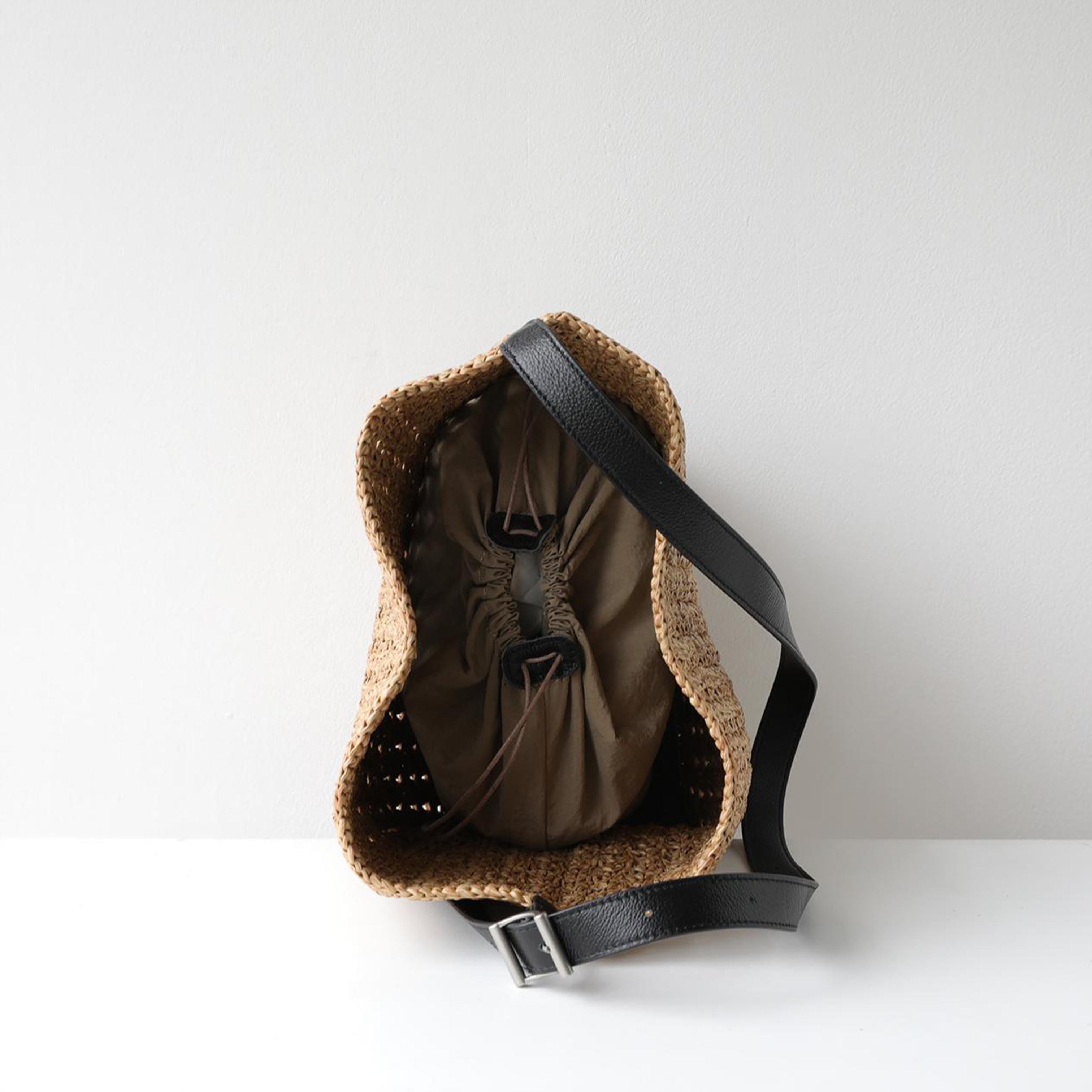 Interior lining and open top view of The Positano raffia hobo bag with genuine leather strap