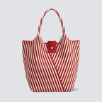 Red and white striped knit summer tote bag on a simple product background
