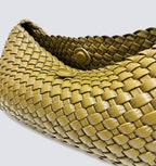 Top-down close-up showing the interior magnetic button closure of the woven bag