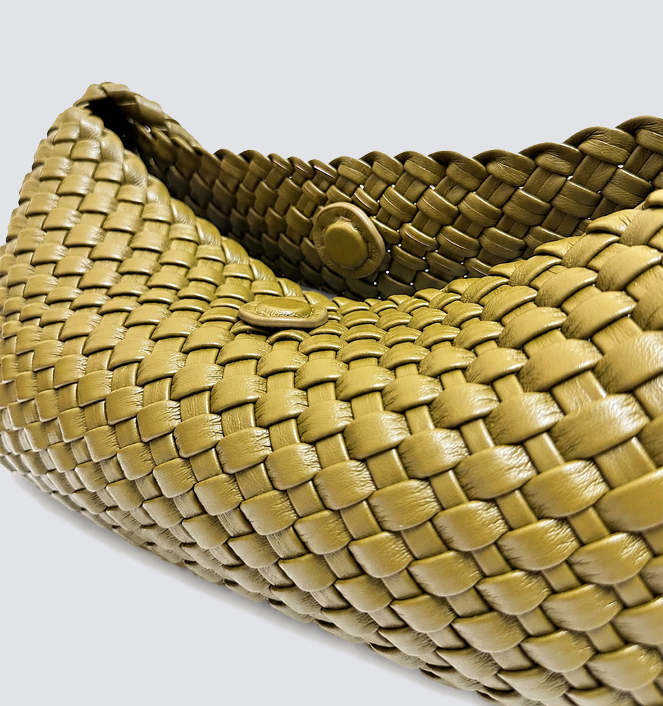 Top-down close-up showing the interior magnetic button closure of the woven bag