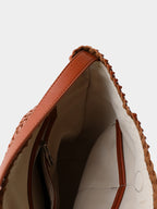 Interior view of the handwoven vegan leather tote bag, featuring a premium light-colored fabric lining, a secure zipper pocket, and a slip pocket for easy organization.