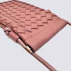 Close-up of the woven texture and knotted strap detail on the mini phone pouch