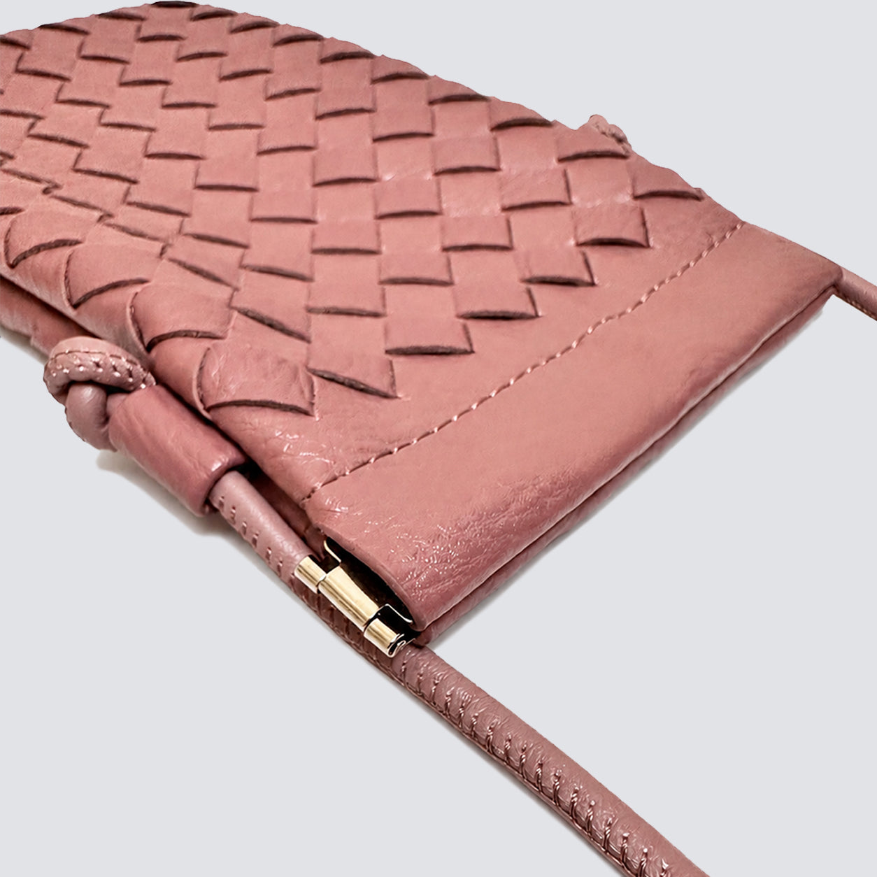 Close-up of the woven texture and knotted strap detail on the mini phone pouch