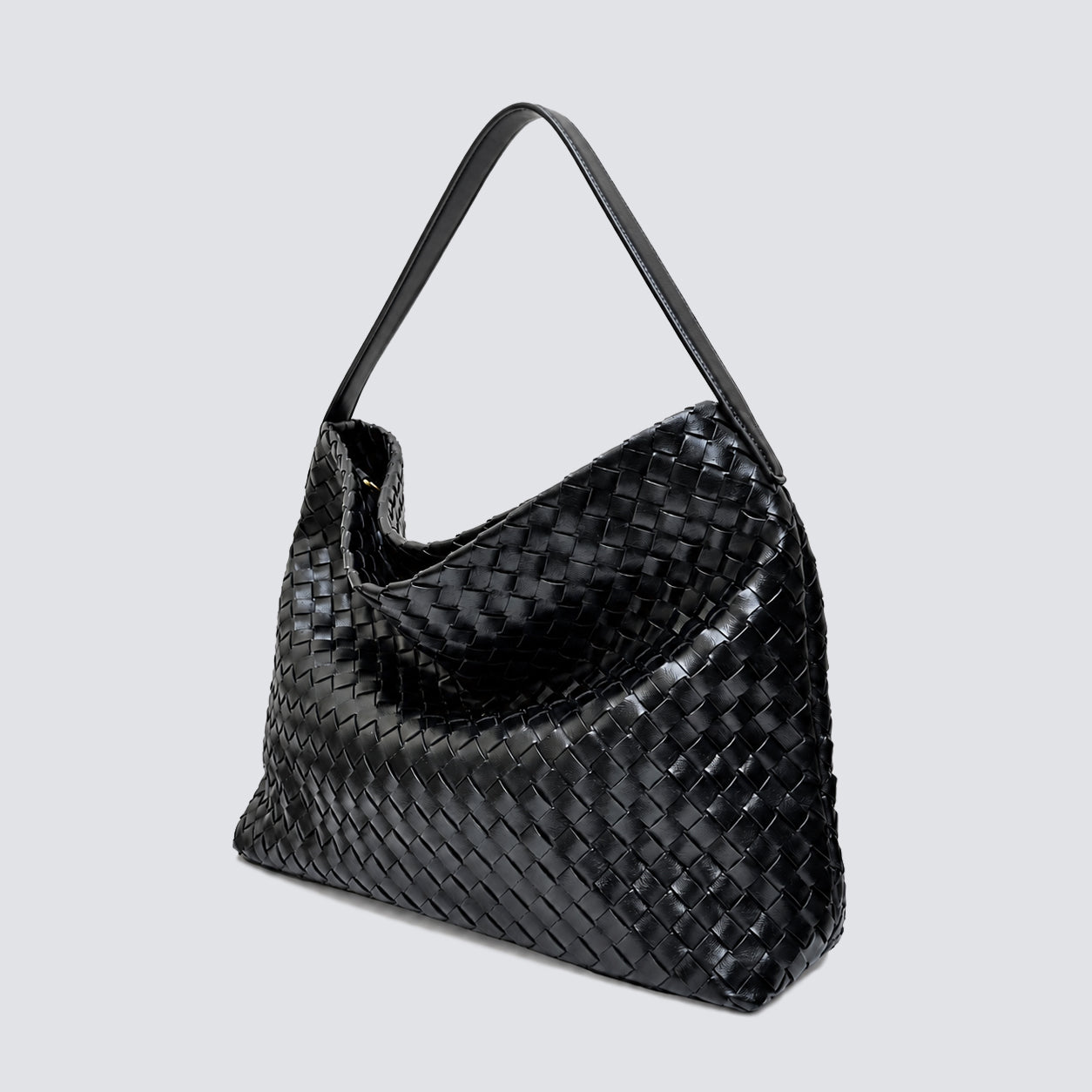 Angled view of the relaxed black woven hobo bag showing its spacious design