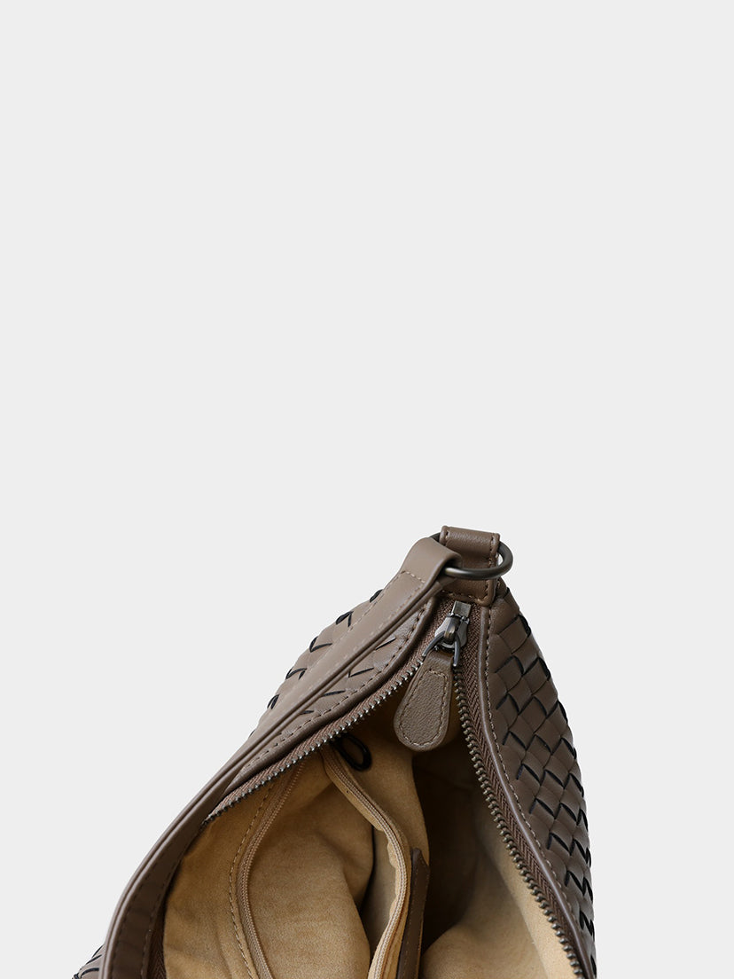 Interior view of woven leather bag with lining and zipper pocket