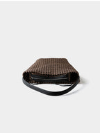 Top-down view into the brown genuine leather woven bag, highlighting the independent secure zipper inner pouch.