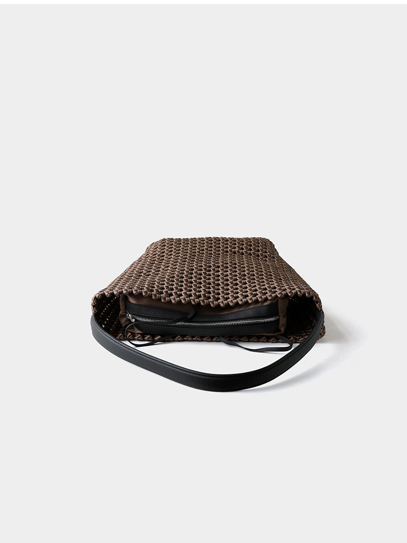 Top-down view into the brown genuine leather woven bag, highlighting the independent secure zipper inner pouch.