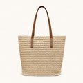 Front view of a light beige woven paper straw tote bag with brown vegan leather straps