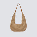Front view of a slouchy woven paper straw hobo bag with a brown shoulder strap