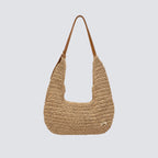 Front view of a slouchy woven paper straw hobo bag with a brown shoulder strap