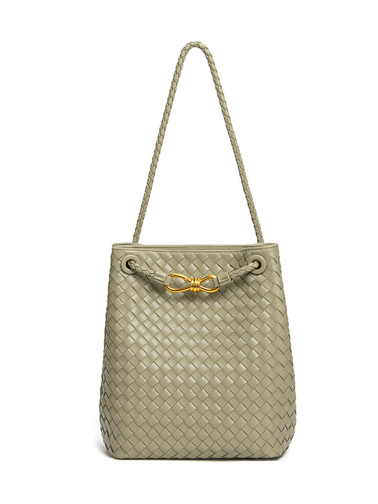 Sage green woven vegan leather bucket bag with braided shoulder strap and gold-tone hardware