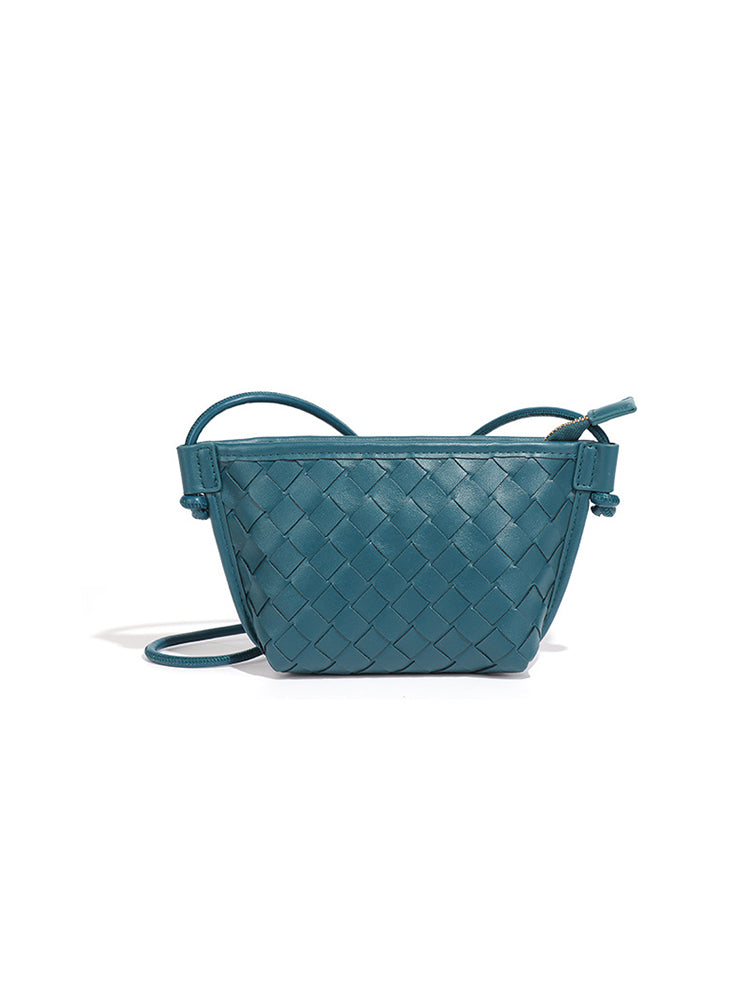Teal blue woven vegan leather crossbody bag with basket weave texture and shoulder strap