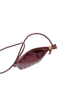 Interior view of the burgundy woven crossbody bag showing the secure zipper closure and premium soft fabric lining.