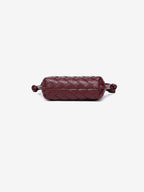 Bottom view showcasing the continuous, meticulous artisan woven texture on the base of the vegan leather mini bag.