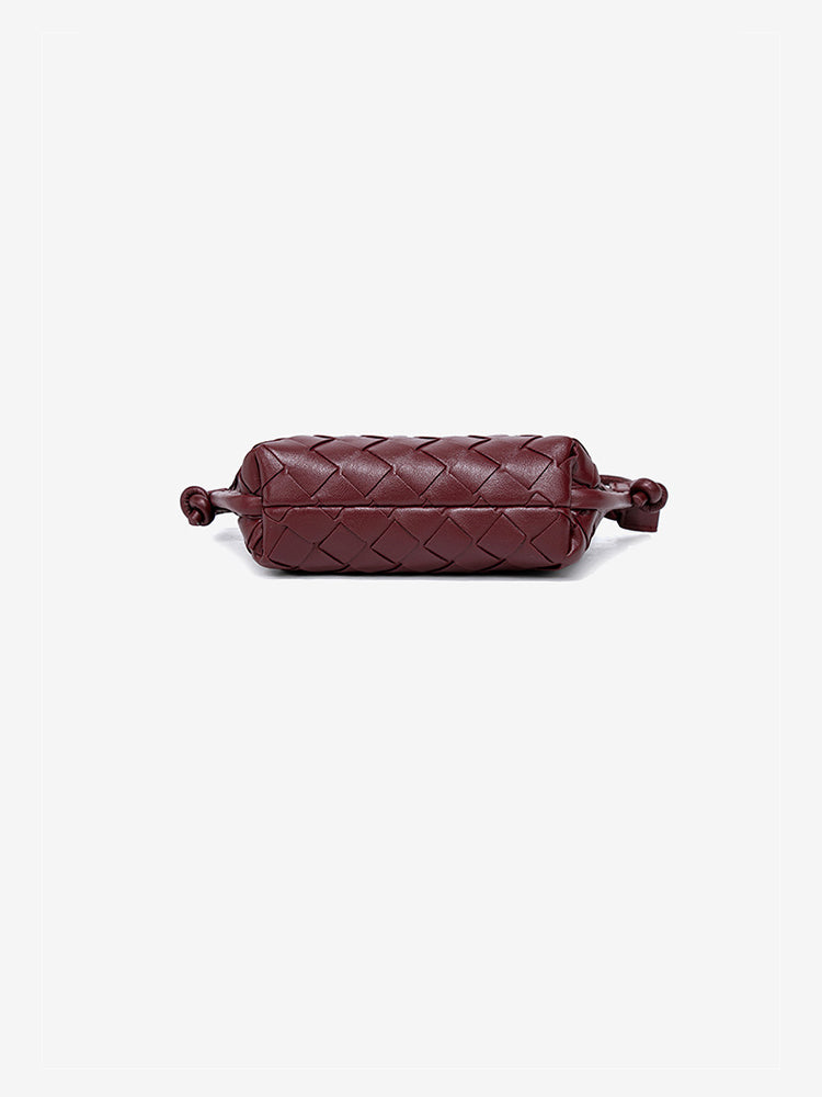 Bottom view showcasing the continuous, meticulous artisan woven texture on the base of the vegan leather mini bag.