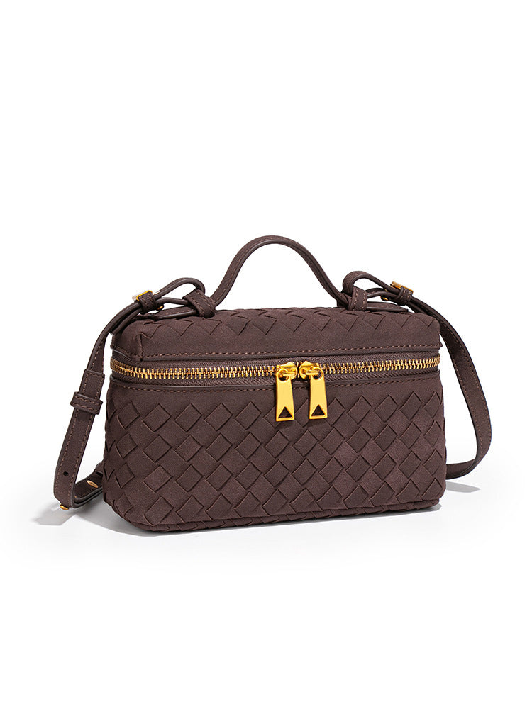 Angled view of chocolate brown woven vegan leather crossbody bag with detachable shoulder strap