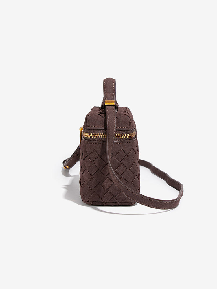 Side view of chocolate brown woven vegan leather crossbody bag with adjustable detachable strap