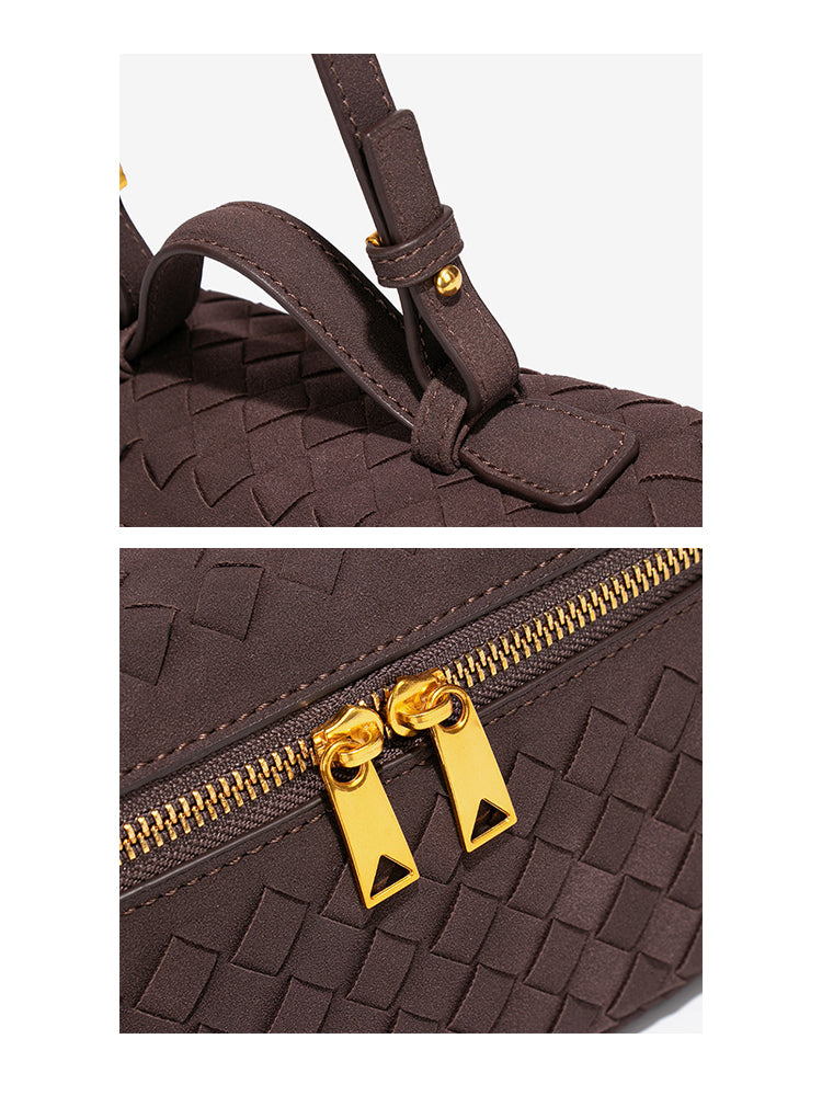 Close-up of adjustable strap hardware and gold double zipper on woven vegan leather crossbody bag