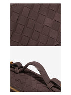Close-up of woven vegan leather texture and stitched top handle on chocolate brown crossbody bag